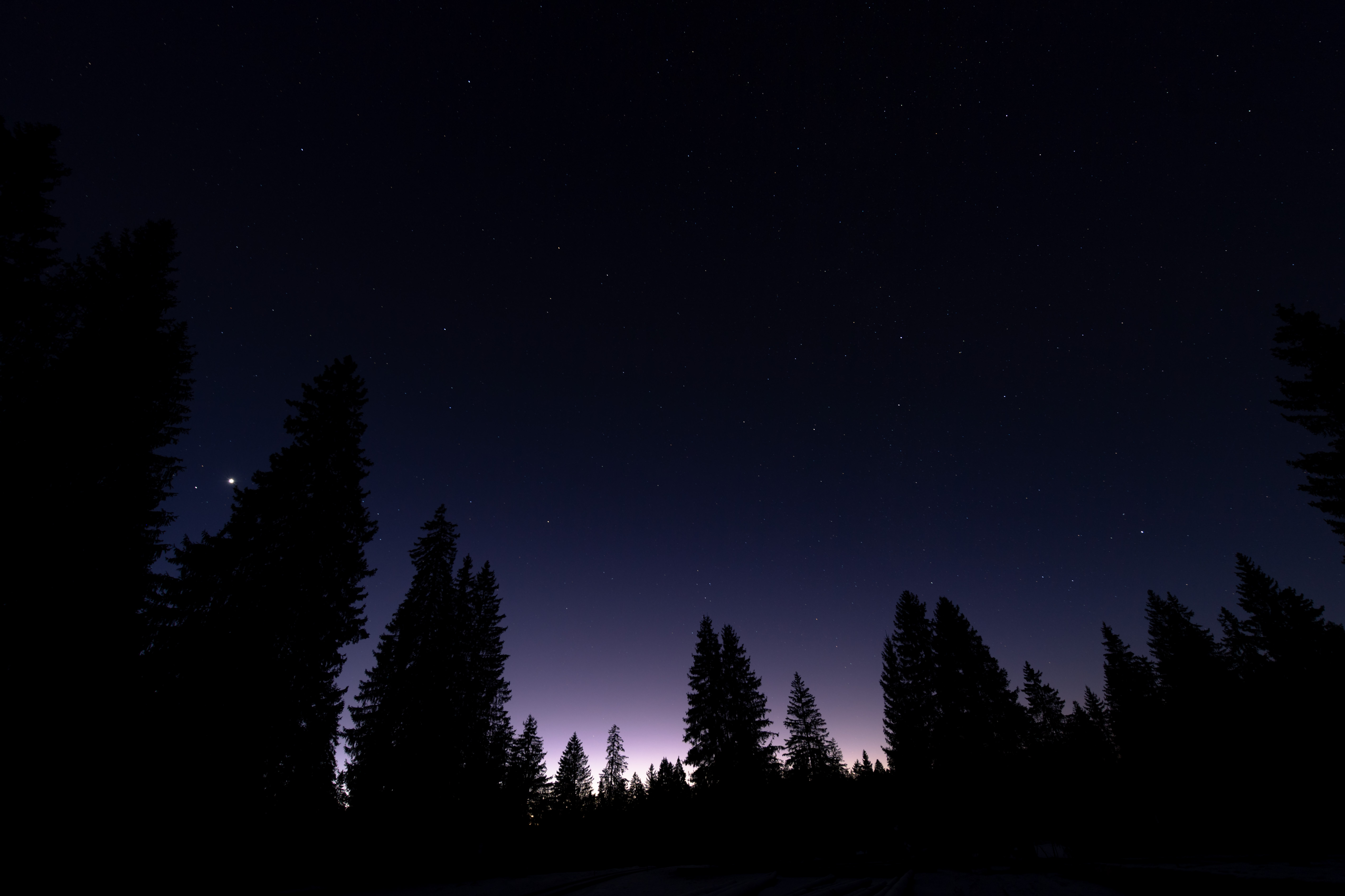 Winter dusk sky over the Jura mountains with silhouetted trees